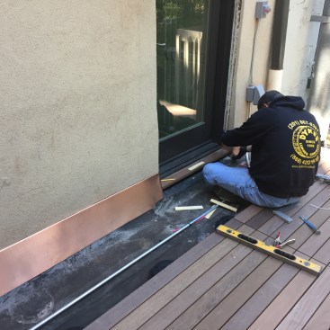 The project included a new door leading out onto the deck. Electrical wiring for bench lighting runs through conduit underneath the deck panels.