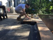 The 2-foot-by-4-foot ipe deck panels rest on pedestals that support the corners and midpoints of the panels. The panels are flush with the top of the ipe curb.