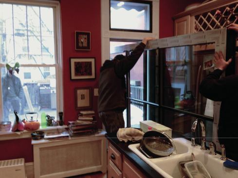 After the heavy door panels were carried up the front entry stairs, they were wheeled on dollies through the house and out the back door.