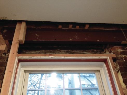 The first, longer steel channel was blocked up on the brick to the left of the kitchen window and the top flange was shimmed along its length.