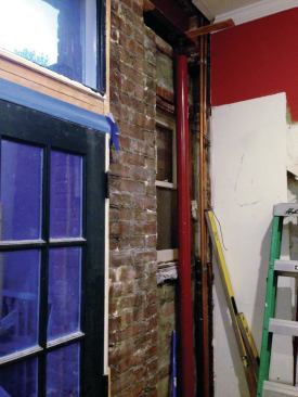 A Lally column was temporarily set in front of the window to support the steel.