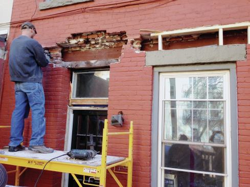 On the outside of the house, bricks were removed first from above the kitchen window, and blocking was added down to the granite lintel to provide temporary support. 