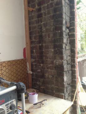 The kitchen window and surrounding brick were removed, leaving the outer wythe intact.