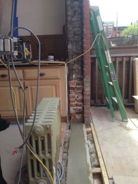 At the door sill, stiff pea-gravel concrete mix was placed in a shallow form over the brick and reinforced with steel mesh.