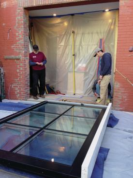 The larger fixed panel was roughly aligned with the opening and laid down on doubled 2-bys covered with movers blankets.