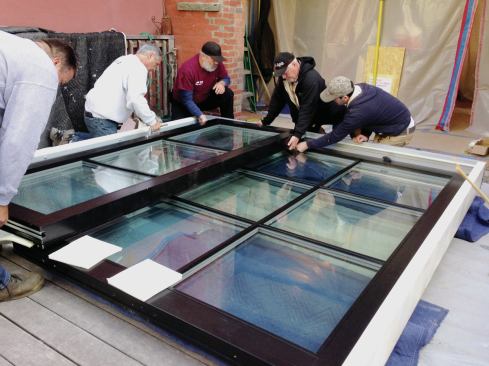 After the frame was shimmed flat, five men lifted it into position.