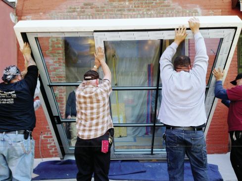 Two men inside and five outside lifted the door and stood it on wood blocks in front of the opening.