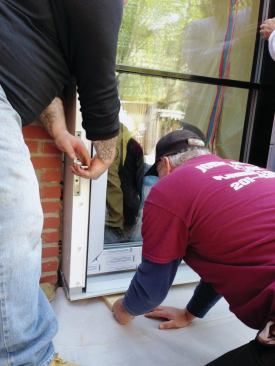 A couple of angle irons fastened back-to-back on each jamb, inside and out, served as handles for inching the door into the opening.