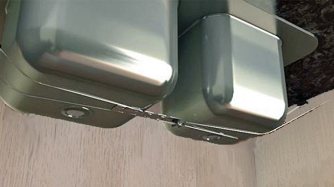 Supporting the flange of an undermount sink with a sink harness can help prevent the surrounding granite countertop from cracking.