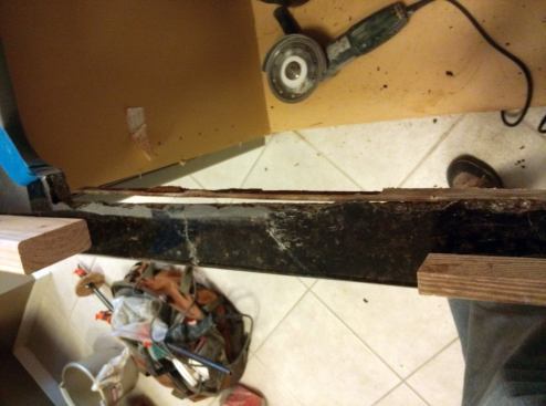 The sink-side length of granite has been cleanly broken off, exposing the rod for easy removal.