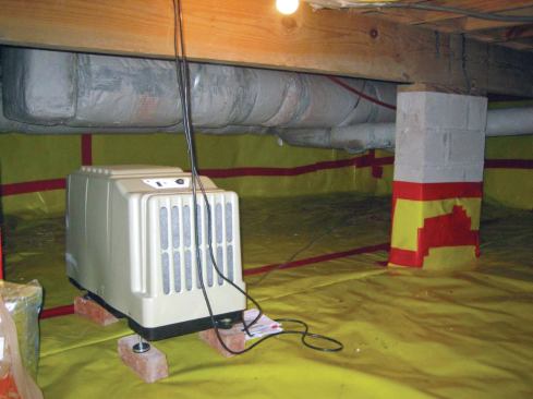 Installing a robust dehumidifier, such as this Therma-Stor Santa Fe model made for basements and crawlspaces, provides the most effective way to manage moisture in an unvented crawlspace.