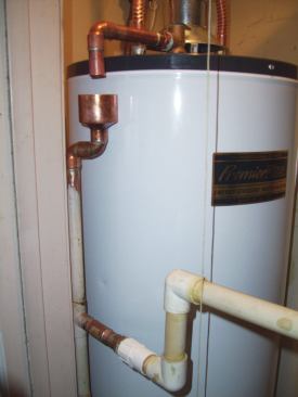 A good way to create an air gap in the discharge pipe is to plumb in a reducer that acts as a cup. The plumbing shown in the photo, however, has created a scald hazard, because the air gap is not within 6 inches of the floor.