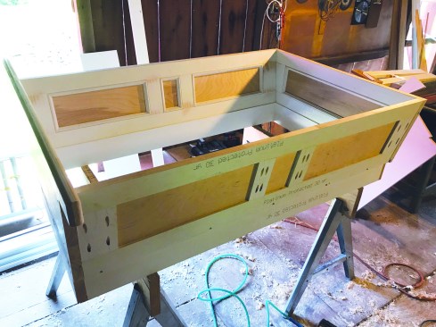 In the shop, the author prebuilt custom window-well trim.