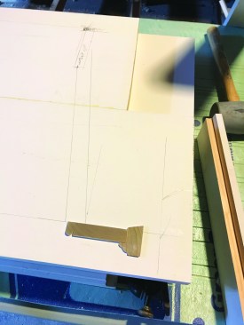 He laid thin wafers of the chosen moldings on each drawing.