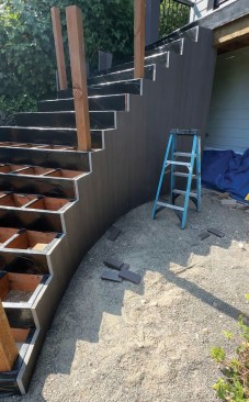 Then I screwed TimberTech dark hickory decking to the skirt rails, installing the decking vertically.