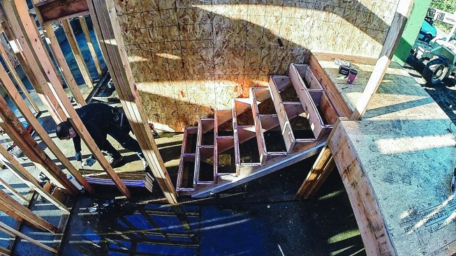 He also applies adhesive to the edge of the tread that butts the riser above it.