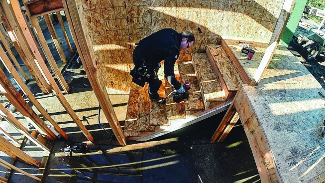 He works his way back down the stairs, nailing off each tread to each riser.
