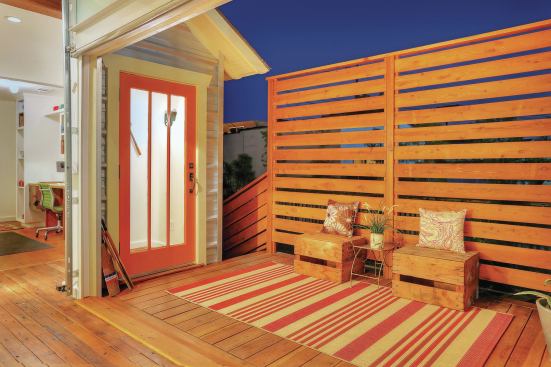 A tall fence screens the deck and provides privacy.