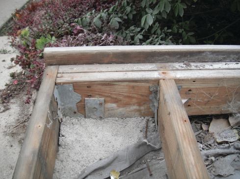 Bearing “on” concrete vs. “in” concrete makes a difference in whether material must be ground contact rated or not.  In this example, placing the lumber in a post base with a standoff would have been a better choice.]