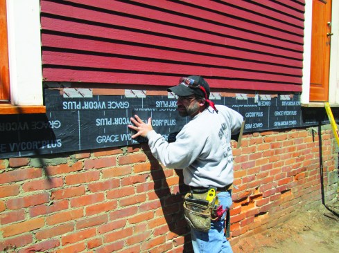Before installing a deck ledger, the author removes the siding and protects the sheathing with a layer of peel-and-stick flashing membrane.