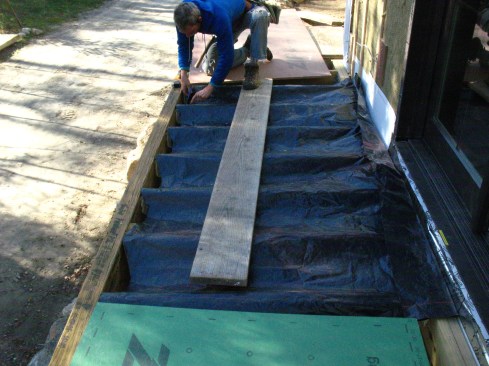 Referring to the dimensions, he snaps chalk lines for the centerline and joists onto the template, then drapes the template over the deck framing so that the chalk lines are aligned with the joists.