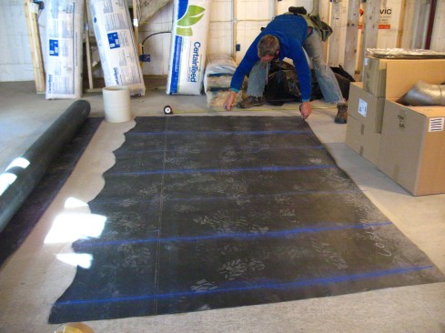 He trims the template to fit, then uses the template as a pattern for cutting out the EPDM membrane.