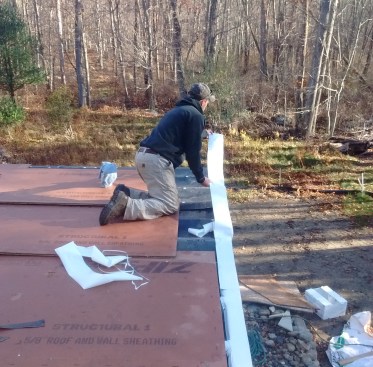 A strip of self-adhering flashing tape covers the joints between the scuppers and protects the rim joist.