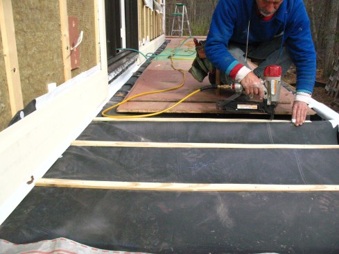 Tapered PT strips installed over the joists provide drainage.