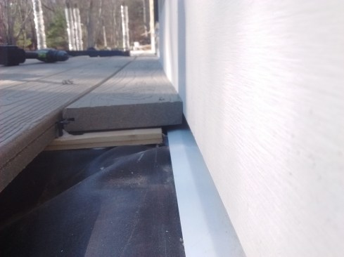 Some siding requires a gap between its bottom edge and the decking, but not in this case.