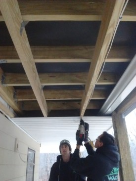 Another option is to install a dropped beadboard ceiling that covers the gutter and rim joist.
