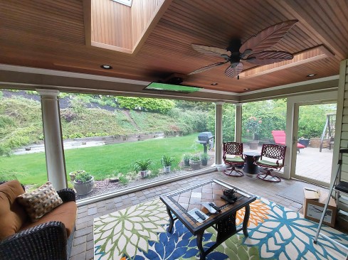 For a basic TV installation on flat and pitched ceilings, the author uses a motorized flip-down mount. On a flat ceiling, the mount can be fitted with a swivel bracket that allows the viewing angle to be adjusted