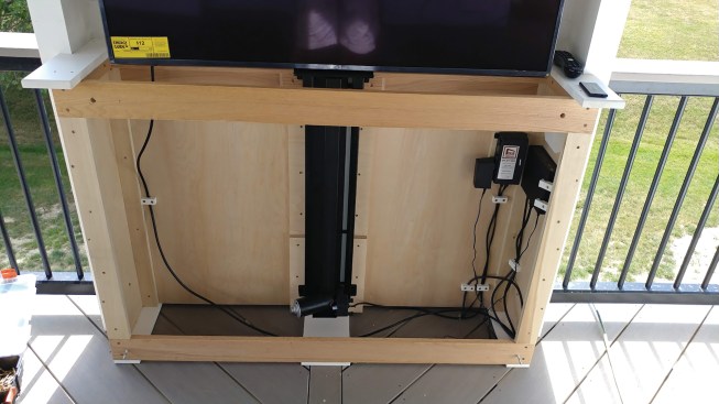 While manufactured outdoor TV cabinets are available, the author prefers to build custom units that he matches to the other finishes in the room and equips with a power pop-up actuator.