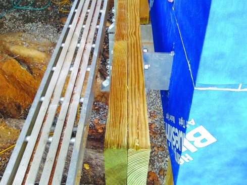 The double 2x12 standoff deck ledger beam is bolted to the deck brackets with hot-dipped galvanized bolts.