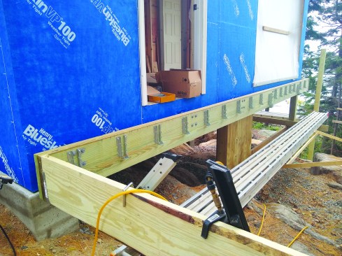 The crew installed galvanized joist hangers.