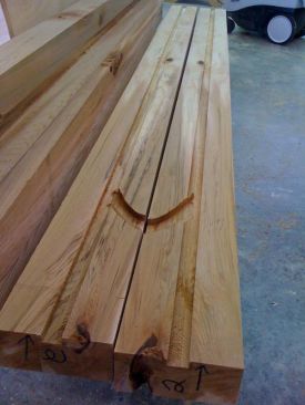 Electrical conduit passes up through the center of each red cedar post. To make channels for it, the author split the posts and and cut a dado on either half. Conduit exits the post above the base via a short channel, which was cut with a router.