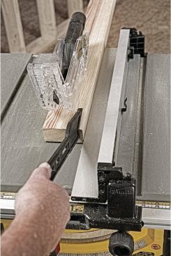 A low auxiliary fence flips down next to the main rip fence to make narrow ripping safer and easier. 
