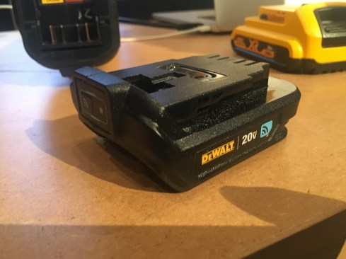 This is the Tool Connect "Connector" (model DCE040). The Connector attaches to 20V Max tools that don't already have Tool Connect capabilities. The device locks onto the tool once it's installed and can't be removed. It has an internal rechargeable coin cell battery that is recharged by the attached 20V Max battery running the tool. The unit allows you to track and manage the tool via DeWalt's Tool Connect app. You can disable the tool from the app, see its last location, and, if it's stolen, potentially locate it if/ when it comes within 100 ft. of other Tool Connect apps. The Connectors are expected to be available this summer and have an MSRP of $39.