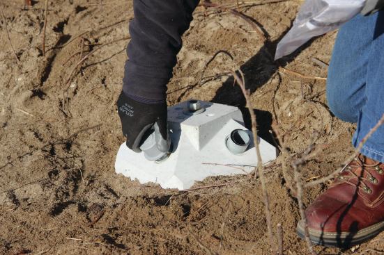 The pins are covered with plastic inspection plugs. They can be removed, allowing a building inspector to measure the pin’s insertion depth with a tape and verify that the installation conforms to the manufacturer’s instructions.