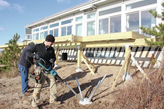 The installer works his way around the pier head, driving each pin about a foot at a time before moving on to the next pin.