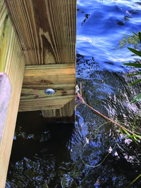 10-inch-long-by-5/8-inch-diameter HDG through-bolts fasten the cross beams to the pilings.