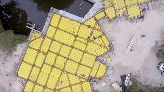 The drone shot shows the extent of the foundation for the house and the hardscaping.
