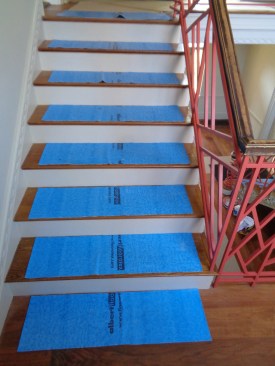 For stairs, the author prefers cushioned foam products, such as Albert Floorotex (above), which sticks without leaving residue or damaging fine finishes.