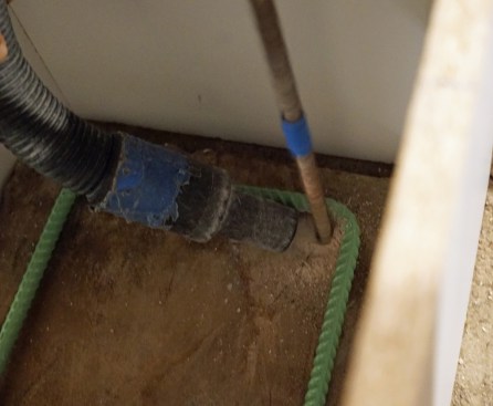 The crew drills into the existing footing for rebar pins.