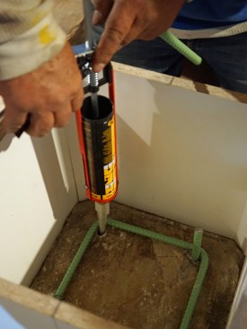 Four pins, each set with epoxy anchor the pier to the old slab.