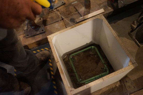 Prior to pouring concrete, the melamine forms are wet with water from a pray bottle. This prevents the form and old concrete from absorbing too much water from the concrete mix, helping to ensure a proper cure. 