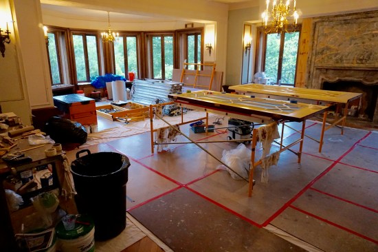 After the floor was wrapped with paper and fully taped hardboard, the room became the staging site for the other trades.