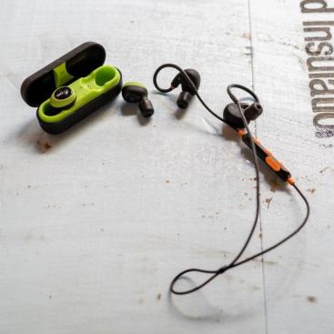 The batteries in the ISOTunes Free earbuds (left) can be recharged by putting the buds in their storage case. The Pro 2.0 earbuds (right) offer better hearing protection and longer battery life, but are connected by a short cord.