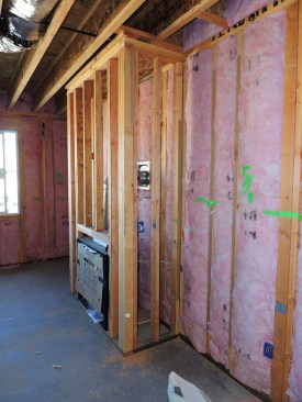 Fireplace inserts are often boxed into framing. (In this case it's a "box-out.") The exterior wall behind the fireplace will be left open to the exterior from an air-sealing perspective after the finish drywall is installed.