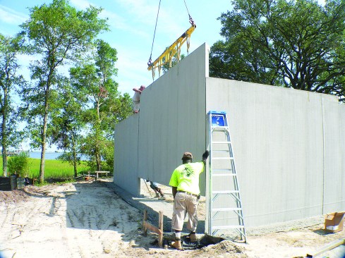 At wall corners, panels are bolted together with through-bolts.Preformed lap joints on adjacent in-line panels are fastened using a bolt and a steel fitting.