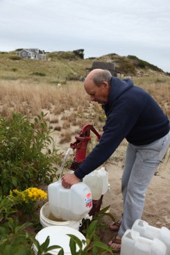 Water for drinking, cooking, and bathing had came from a well on the propery. Here the author fills recycled plastic jugs with remarkably good tasting fresh water. 